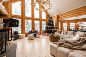 a living room with a christmas tree in it at Chalet Golden Bear - Fiddler Lake in Mille-Isles
