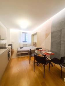 a room with a bed and a table and chairs at Porta Nuova Apartment in Milan