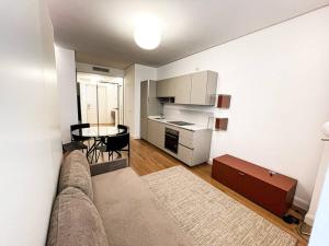 a living room with a couch and a table at Porta Nuova Apartment in Milan