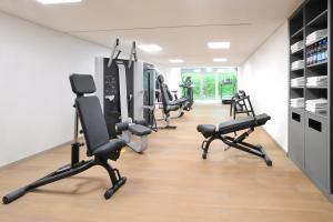 a gym with several treadmills and exercise bikes at Schlosshotel Monrepos in Ludwigsburg