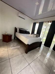 een slaapkamer met een bed in een kamer bij CABAÑAS DEL LAGO / BUNGALOWS in San Ramón