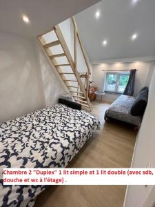 a bedroom with a bed and a staircase at Duplex sympa Verviers in Verviers