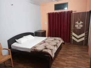 a bedroom with a bed and a red curtain at Shri Niwas Homestay in Ayodhya