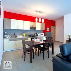 a kitchen and dining room with a table and chairs at E&D Apartments in Antananarivo