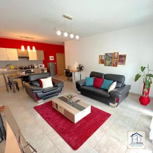a living room with two couches and a coffee table at E&D Apartments in Antananarivo