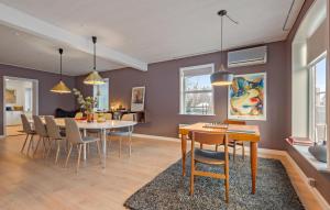 a dining room and living room with a table and chairs at Nice Home In Bredebro With Wifi in Bredebro