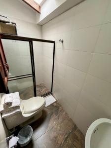 a bathroom with a toilet and a sink at CasaBlanca Boutique in Cali +39 photos
