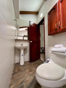 a bathroom with a toilet and a sink at CasaBlanca Boutique in Cali