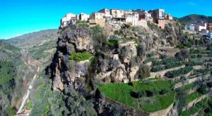 a village on the side of a mountain at APARTAMENTO RURAL LA CANDELARIA in Elche de la Sierra