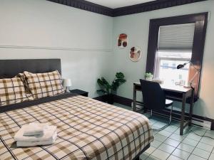 a bedroom with a bed and a desk with a computer at Comfy Apt, Top Floor, Excellent Kitchen in Halifax