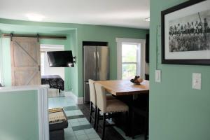 uma sala de jantar com paredes verdes e uma mesa e cadeiras em Comfy Apt, Top Floor, Excellent Kitchen em Halifax