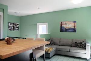 a living room with a table and a couch at Comfy Apt, Top Floor, Excellent Kitchen in Halifax