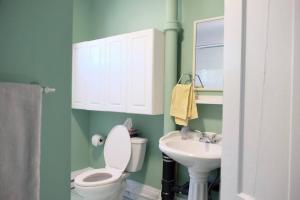 a bathroom with a toilet and a sink at Comfy Apt, Top Floor, Excellent Kitchen in Halifax