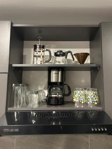 a shelf with a coffee pot and glasses on it at • POWER STYLE • Apto con terraza in Bogotá