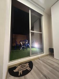 a room with a large window with a table and chairs at • POWER STYLE • Apto con terraza in Bogotá