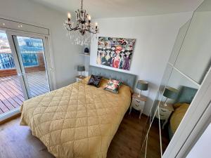 a bedroom with a bed and a chandelier at Magnificent penthouse in Barcelona