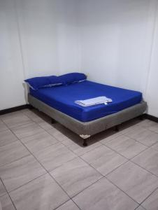 a bed in a room with a blue mattress at casa playa negra in Puerto Limón