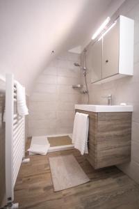 a bathroom with a sink and a bath tub at Giù nei Sassi in Matera