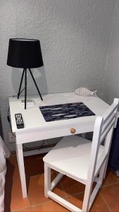a white desk with a lamp and a chair at OR Tambo Stay Unit 2 in Boksburg