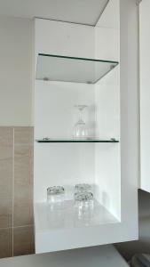 a glass shelf with two glasses on top of it at Sopocachi BnB - Chic Apartment in La Paz