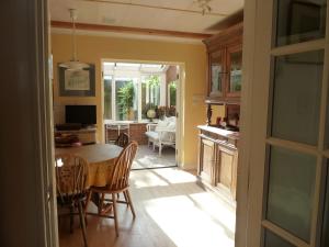 a kitchen and dining room with a table and chairs at Spacious in Croxley Green