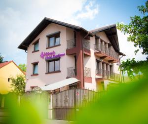 a pink building with a sign on it at Hotel Boutique Mikaela (Adult Only) in Braşov