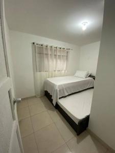 a small bedroom with a bed and a window at Apartamento cómodo y agradable in Medellín