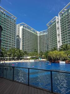 a large resort building with a large swimming pool at Azure Staycation in Manila