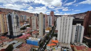 an aerial view of a city with tall buildings at Sopocachi BnB - Chic Apartment in La Paz