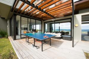 a ping pong table in the middle of a house at Collection Luxury Accomodation Simola House in Knysna