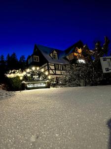 a house with lights in the snow at night at Helenenhof in Kurort Altenberg