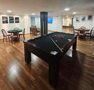 a pool table in the middle of a room at Verdes Pássaros Apart Hotel in Florianópolis