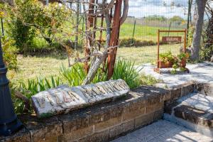 a stone bench sitting on a brick wall at Villa Marianna in Vasto