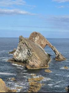 a large rock sitting in the middle of the ocean at Lochside Loft - Self Catering Apartment for 2 In a great location for Inverness Airport and both Cabot Highlands & Nairn Golf Courses in Inverness