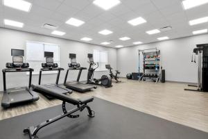 a gym with treadmills and exercise bikes in it at Hampton Inn By Hilton Cornwall in Cornwall