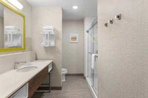 a bathroom with a sink and a toilet at Hampton Inn By Hilton Cornwall in Cornwall