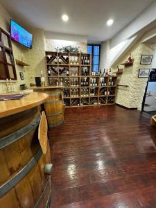 a wine tasting room with wooden floors and wine barrels at Patche Residence - A Wine Cellar Hideaway in the Historic Home of Revolutionary Metodi Patche in Ohrid
