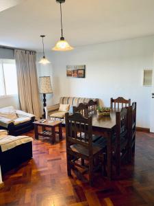 a living room with a table and chairs and a couch at Departamento Centrico in Mendoza