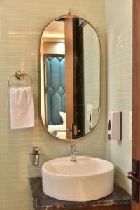a bathroom with a sink and a mirror at Hotel Shree Krishna in Jaipur