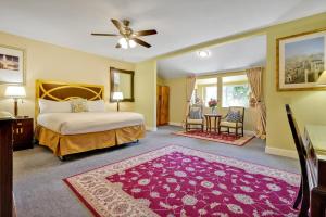 a bedroom with a bed and a table and chairs at Bodega Bay Inn in Bodega Bay