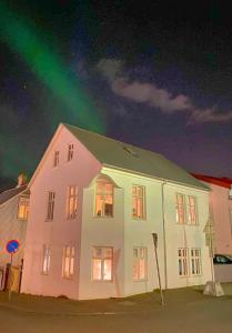 a house with a rainbow in the sky at Enjoy Reykjavík Yellow Door Apartment in Reykjavík