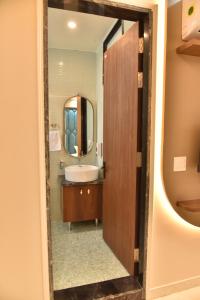 a bathroom with a sink and a mirror at Hotel Shree Krishna in Jaipur