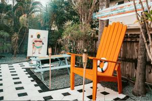 a patio with two chairs and a table and a bench at Las Olas Guest House in Fort Lauderdale