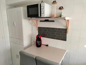 a small kitchen with a table and a microwave at Casa Tito 2 in Santo Domingo de la Calzada