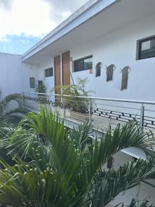 a white building with some plants in front of it at Hotel Boutique Murana Tulum in Tulum
