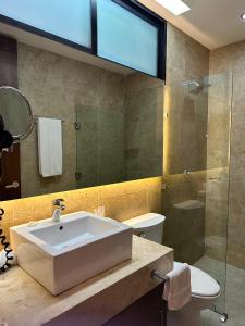 bagno con lavandino e doccia in vetro di Hotel Boutique Murana Tulum a Tulum