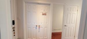 a white closet with two white doors in a room at Mainfloor Spacious Room in Toronto in Toronto