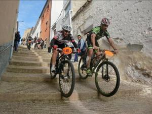 two men riding bikes down a set of stairs at APARTAMENTO RURAL LA CANDELARIA in Elche de la Sierra