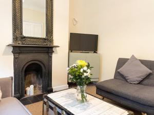 a living room with a fireplace and a mirror at Waverley Lodge - Quaint Victorian Home With Free Parking in York