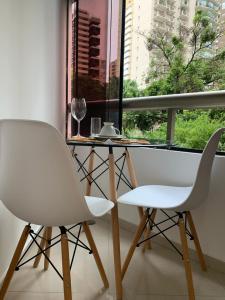 a table and two chairs in a room with a window at Royal Ibirapuera Park in Sao Paulo